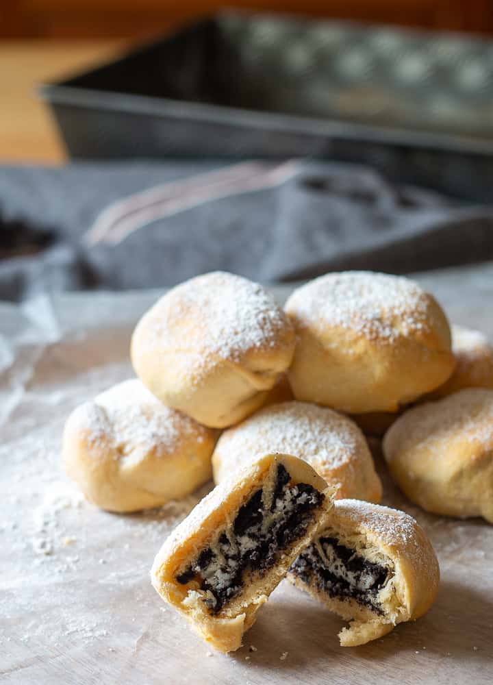 stack of freshly made air fryer deep fried oreos wrapped in refrigerated crescent roll dough and topped with powdered sugar sprinkles