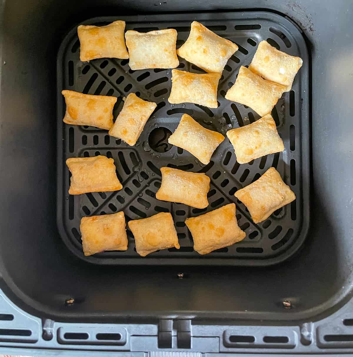 Air fryer pizza rolls after being heated up in air fryer basket