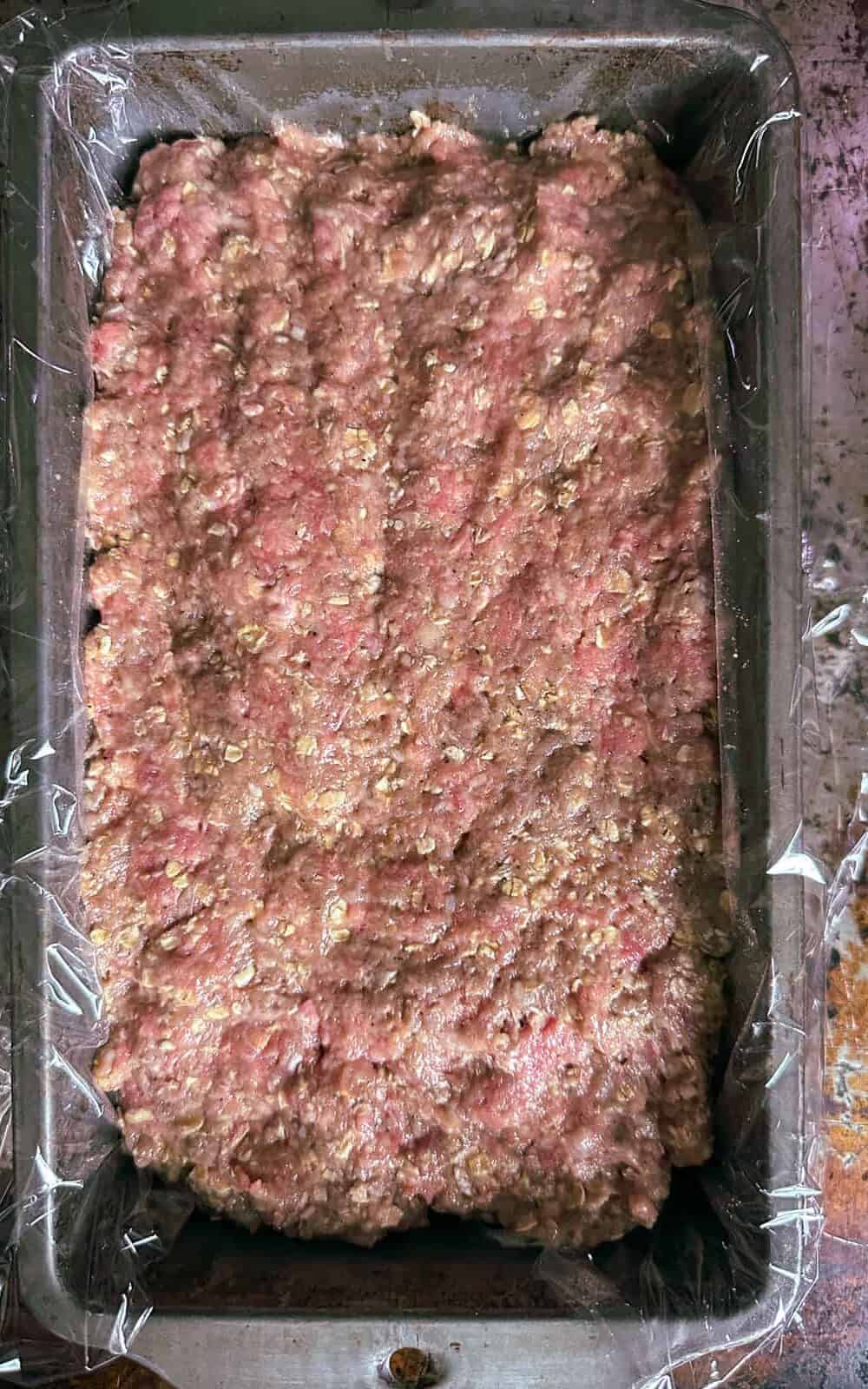 air fryer meatloaf raw meat mixture in a loaf pan